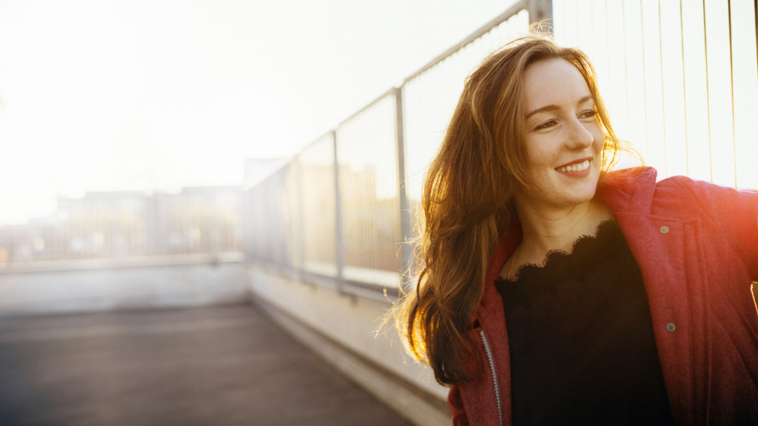 modern young woman portrait in urban scene with back lit